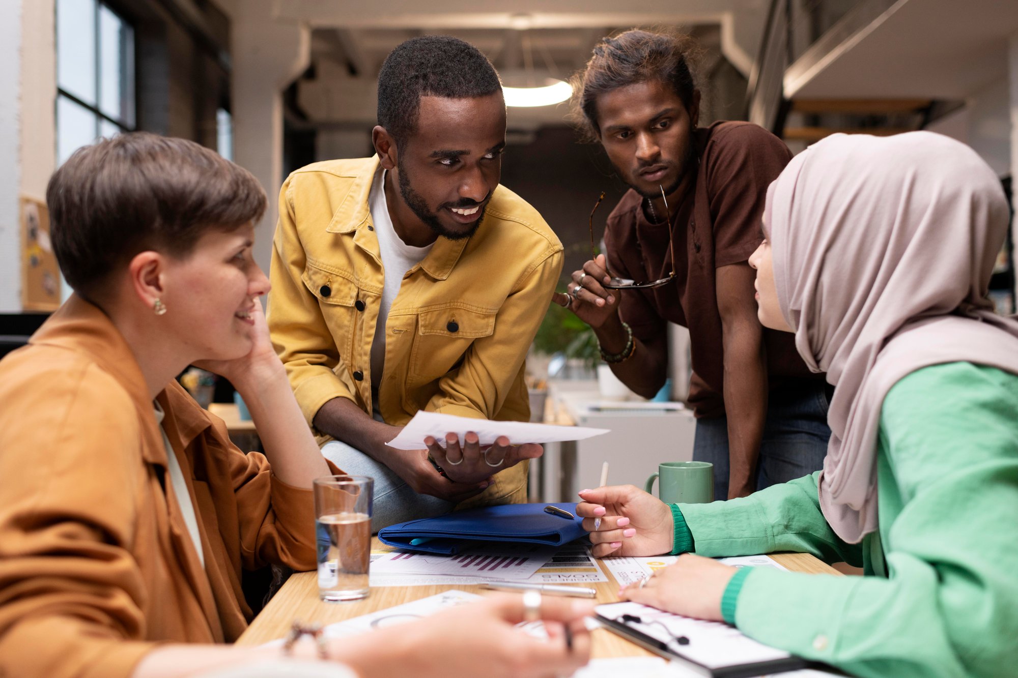 medium-shot-colleagues-discussing-table